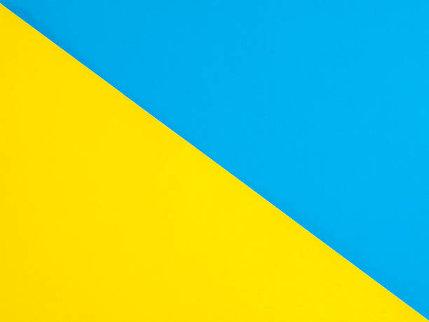 istock colored blue and yellow paper background divided in half, splash screen 1359225053
