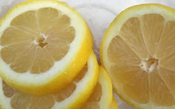 Lemon fruit slices close up food photo background.