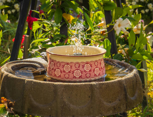 istock bubbling fountain in a garden 1359226139