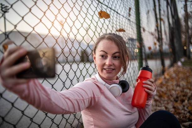 istock Fitness woman exercises outdoors, has finished training and is resting. 1359226219