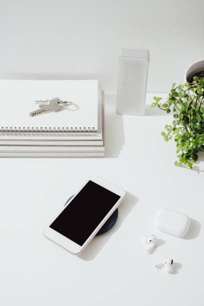 istock Smartphone Charging on a Wireless Charger at Home 1359227024