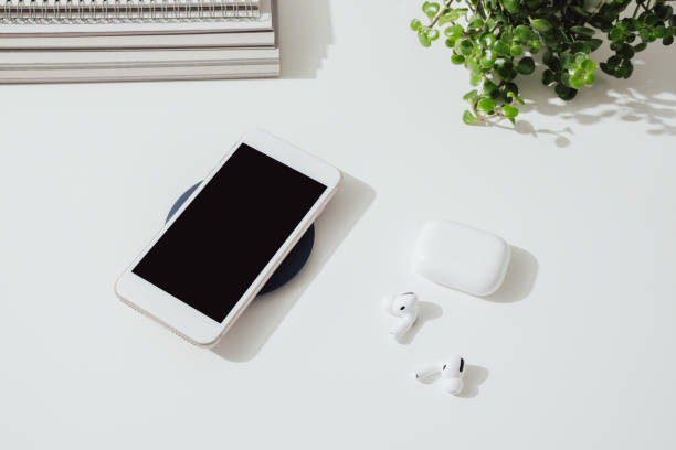 istock Smartphone Charging on a Wireless Charger at Home 1359227034