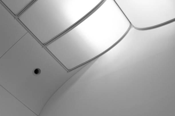 istock Ceiling with plastic panels and nozzle of air conditioning (or ventilation) duct. Abstract modern architecture, interior design and technology photo with geometric structure of lines and curves. 1359228215