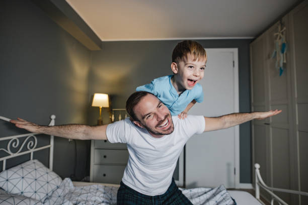 istock Cute boy playing with his father in the morning 1359235120