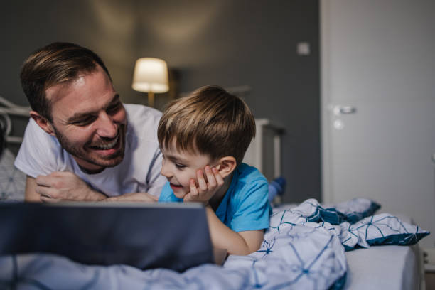 istock Father and son using laptop in the morning 1359235790
