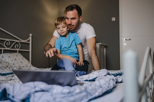 istock Father and son using laptop in the morning 1359236076