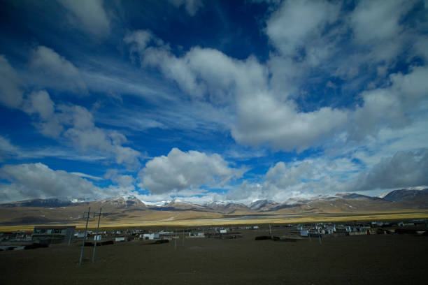 istock The blue sky white clouds and grassland snow mountain landscape 1359240159