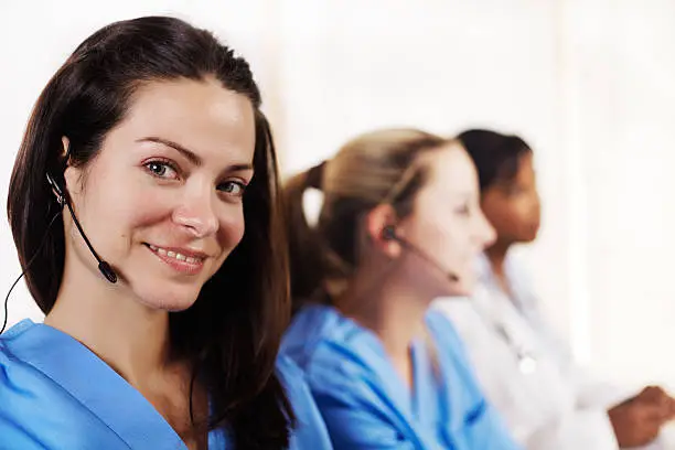 Portrait of a smart young female nurse talking in a callcenter