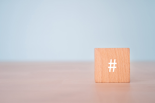 A wooden block with a hash tag sign.