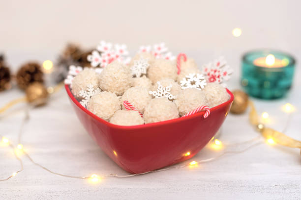 istock Christmas tables cape decorations with small snow balls, garland and lights. Selective focus. Cozy Xmas or New Year holidays atmosphere 1359242590