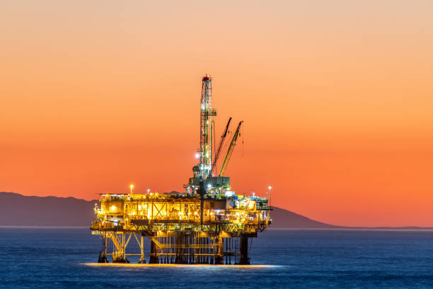 istock Offshore oil platform at dusk 1359245108