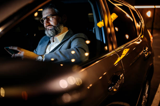 istock Well dressed businessman in his car 1359246113