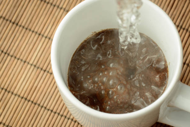 istock Pouring boiling water to the cap with ground coffee and sugar 1359246703
