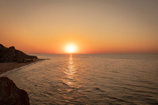 istock Sunset on the sea coast. Rocks and sea. 1359248087