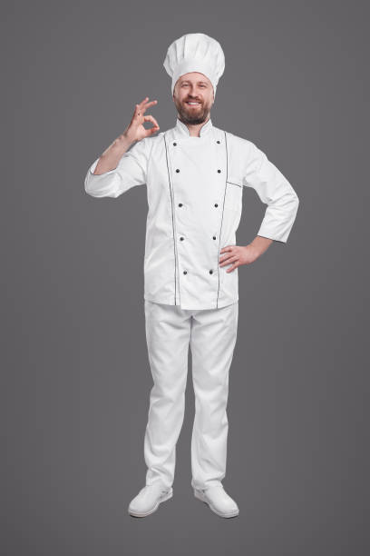istock Confident chef in uniform showing okay gesture 1359248101