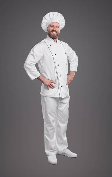 istock Confident chef in uniform on gray background 1359248138