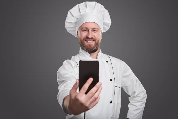 istock Cheerful chef taking selfie on smartphone 1359248141