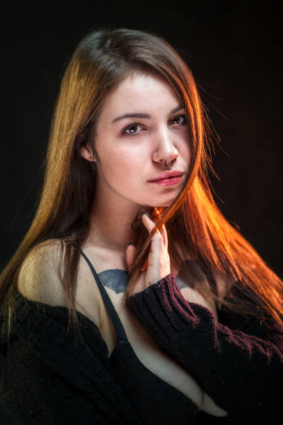 Portrait of a young brown haired woman with tattoos