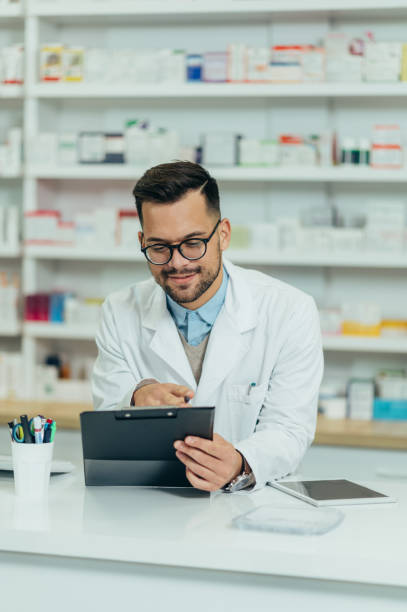 istock Portrait of a handsome pharmacist working in a pharmacy 1359248324