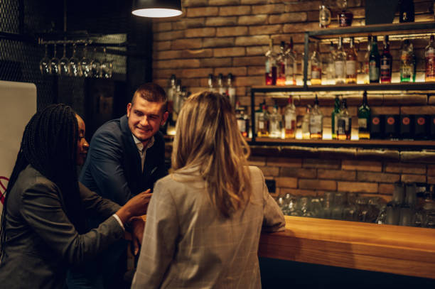 istock Cheerful colleagues drinking beer in the bar together after work and using a tablet 1359248351