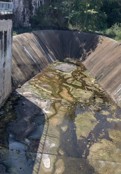 istock Dried up empty reservoir or small concrete dam due to a summer heatwave. 1359248461
