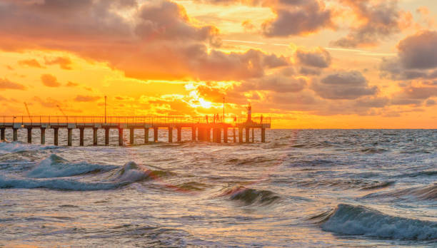 istock Pier on the sea, orange sunset on the background 1359248474
