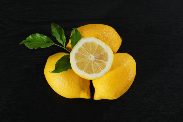 istock A yellow lemon against a black background. 1359249164