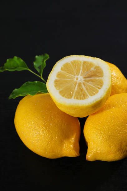 istock A yellow lemon against a black background. 1359249167