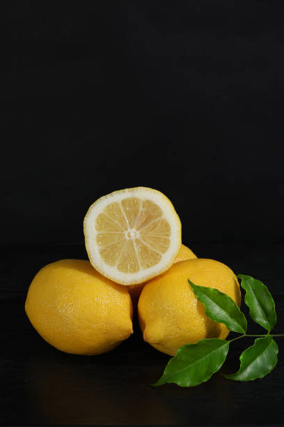 istock A yellow lemon against a black background. 1359249168