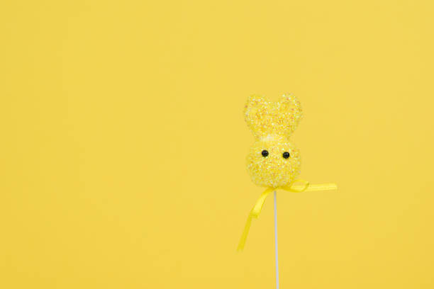 istock Yellow Easter bunny on a yellow background. Color trend. 1359255391