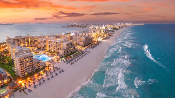 Cancun beach during with red sunset and blue hour stock photo