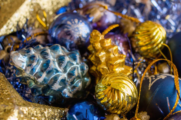 istock Gold and blue Christmas decorations on silver and blue background - closeup 1359259686