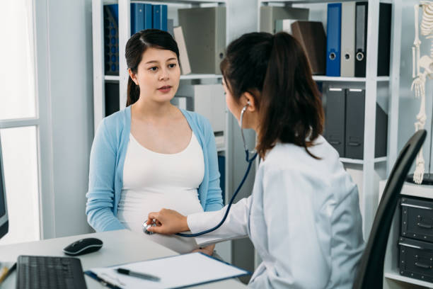 istock asian woman having pregnancy checkup while the gynecologist is using a stethoscope on her belly to listen to baby heartbeat in the clinic. 1359264270