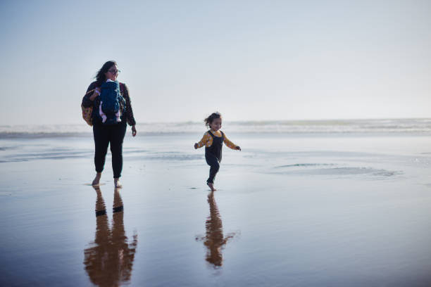istock Family Walking on the Beach Together 1359264552