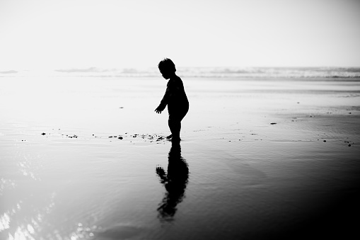 A curious little girl exploring the Oregon Coast. Edited to black and white in post processing.