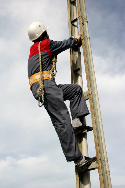 istock Technician climbing to electricity power line pole 1359269976