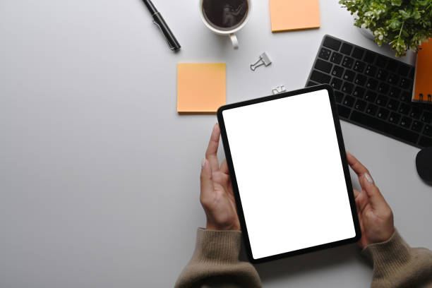 istock Above view businesswoman using digital table at her office desk. 1359271409
