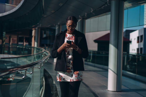 istock Businesswoman types message on the move 1359274230