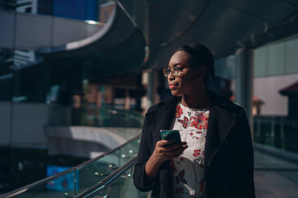 istock Businesswoman types message on the move 1359274234