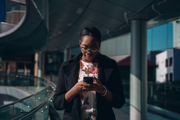 istock Businesswoman types message on the move 1359274235