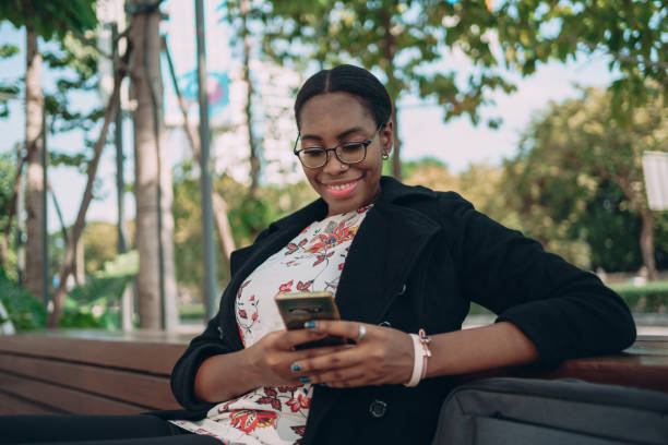 istock Smiling woman using a phone 1359274296