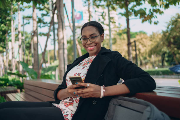 istock Smiling woman with a phone 1359274955