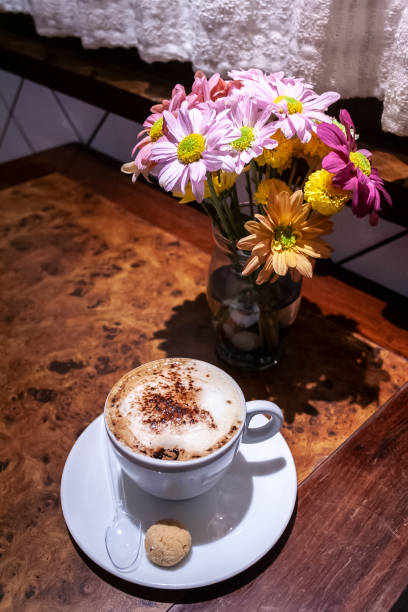 istock Cup of coffee and gerberas flowers 1359275796