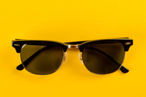 istock Trendy eyeglasses on yellow background 1359275981