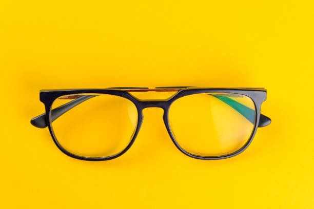 istock Trendy eyeglasses on yellow background 1359276015