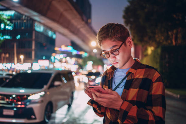 istock Man using a phone in the city 1359276706