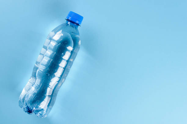 istock Water bottle on blue background registered in studio. 1359276769