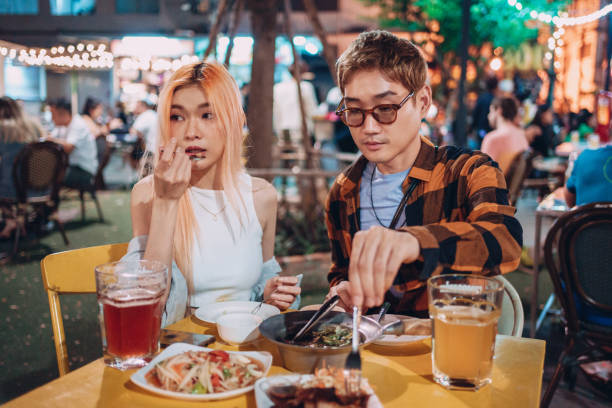 istock Friends having dinner on a night market 1359276782