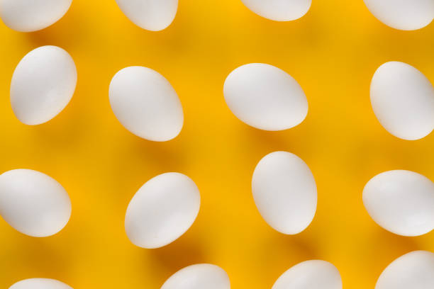 istock Farm fresh eggs on yellow background. 1359276839