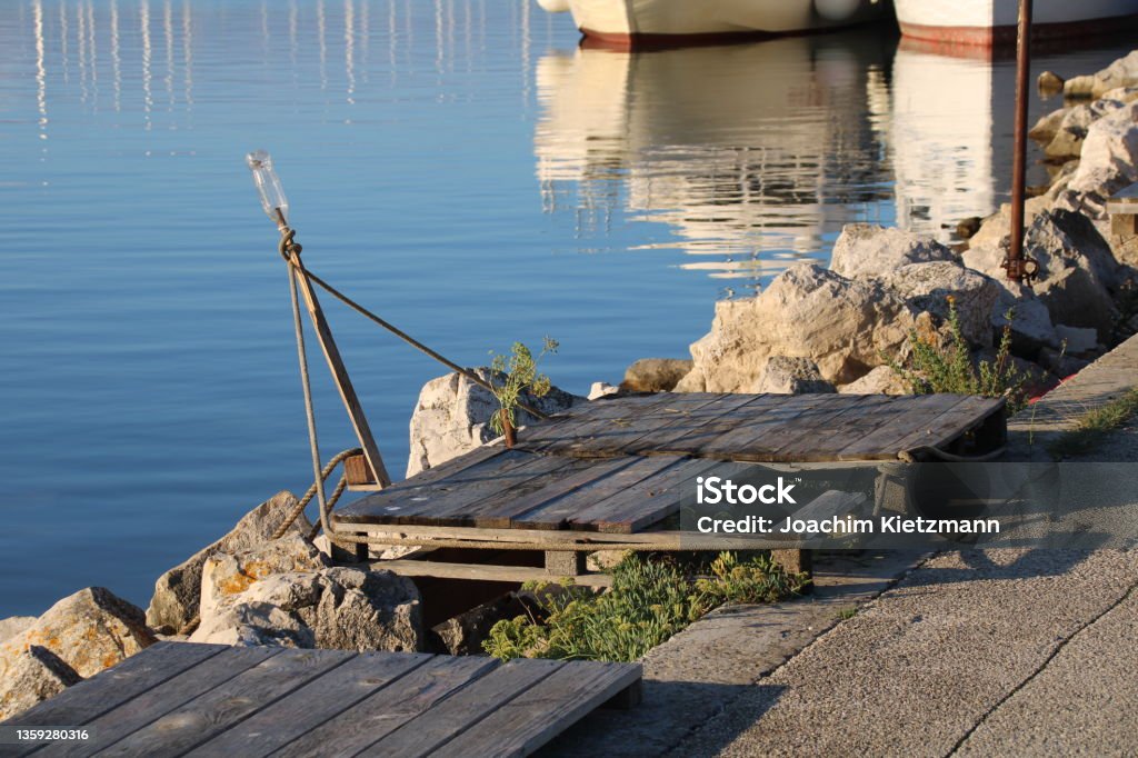 Medulin Pomer Istria Croatia - Palette and flowers at the jetty Summer on the Mediterranean Bikepacking Stock Photo
